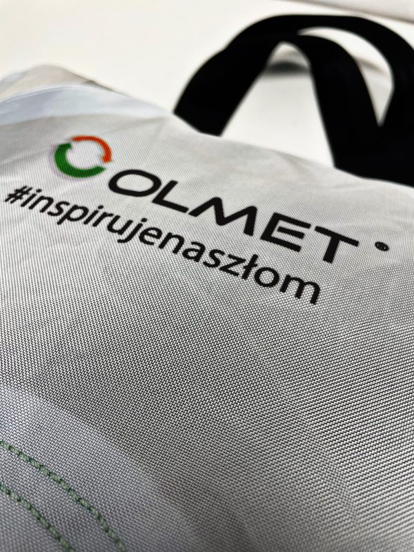 Torba z nadrukiem logo OLMET i hasłem #inspirujenaszłom — przykład merchu firmowego